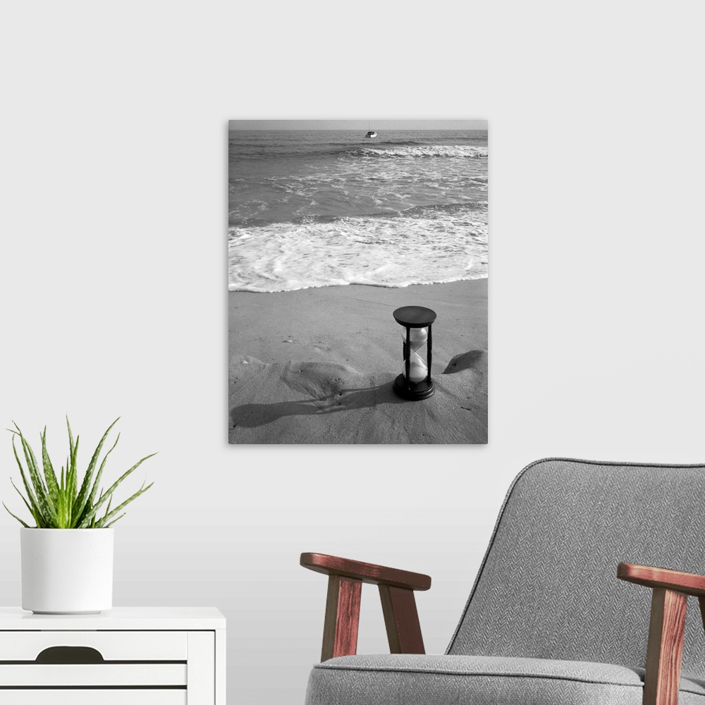 A modern room featuring 1960's Still Life Of Hourglass At Edge Of Beach Sand With Waves Washing Up On Shore And Power Boa...