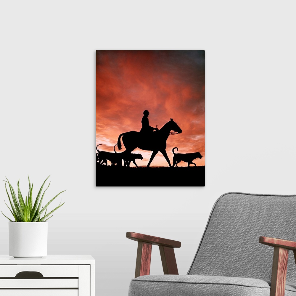A modern room featuring 1970s Silhouetted Anonymous Man Riding Horseback With Foxhound Dogs On Fox Hunt.