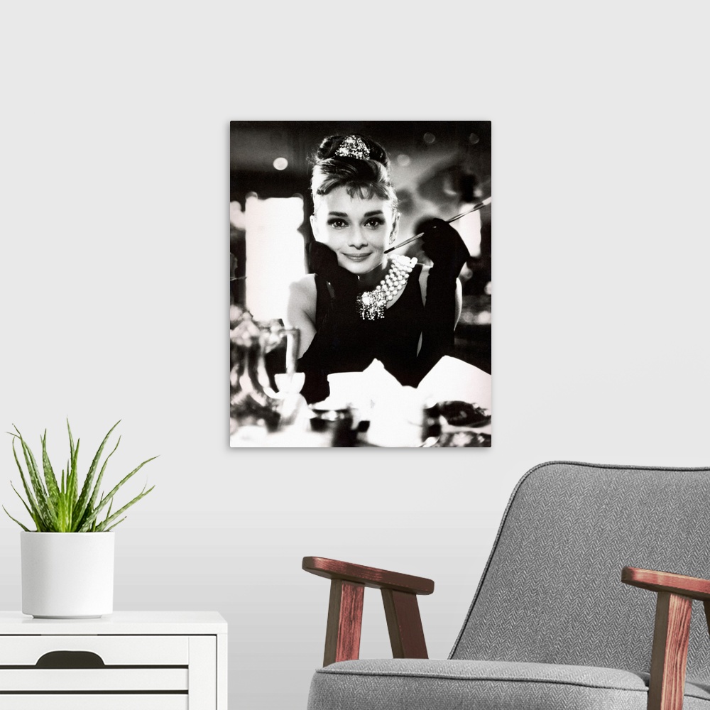 A modern room featuring Classic iconic photograph of Audrey Hepburn sitting at a table holding a cigarettte and smiling.