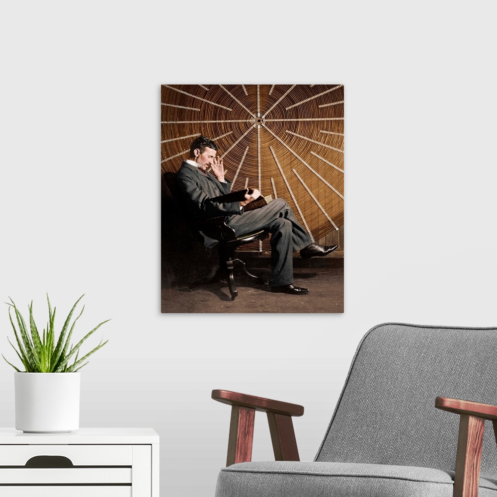 A modern room featuring Nikola Tesla (1856-1943), Serb-US physicist, seated in front of the spiral secondary coil of a hi...