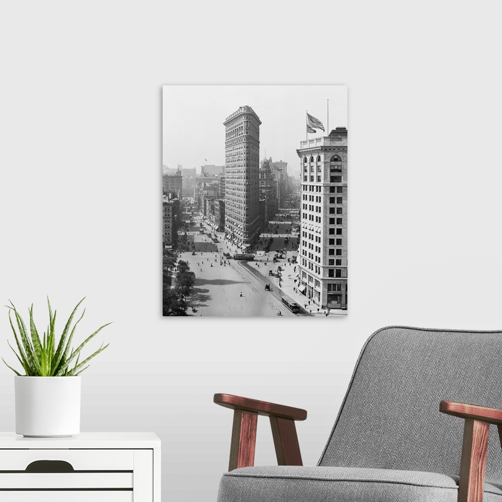 A modern room featuring American history photo featuring the Flatiron Building, an iconic New York City skyscraper, circa...