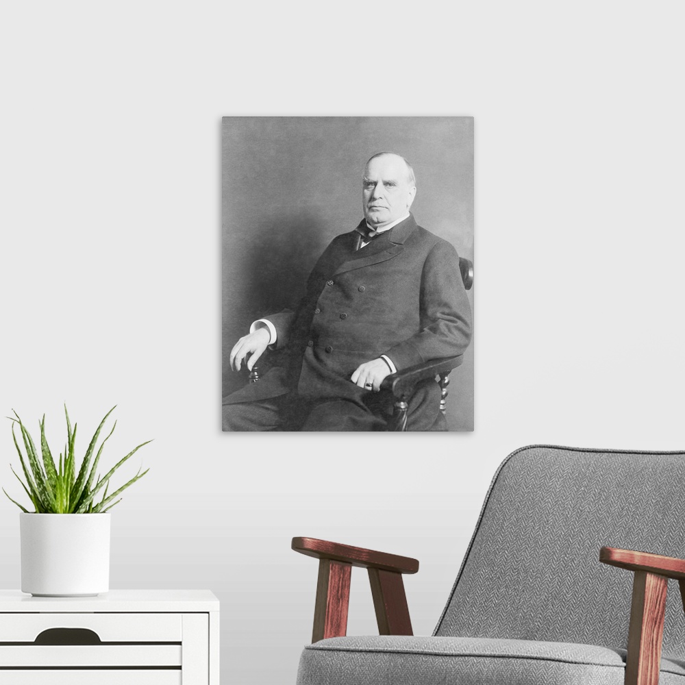 A modern room featuring President William C. McKinley, three-quarter length portrait, seated, facing left, circa 1900.