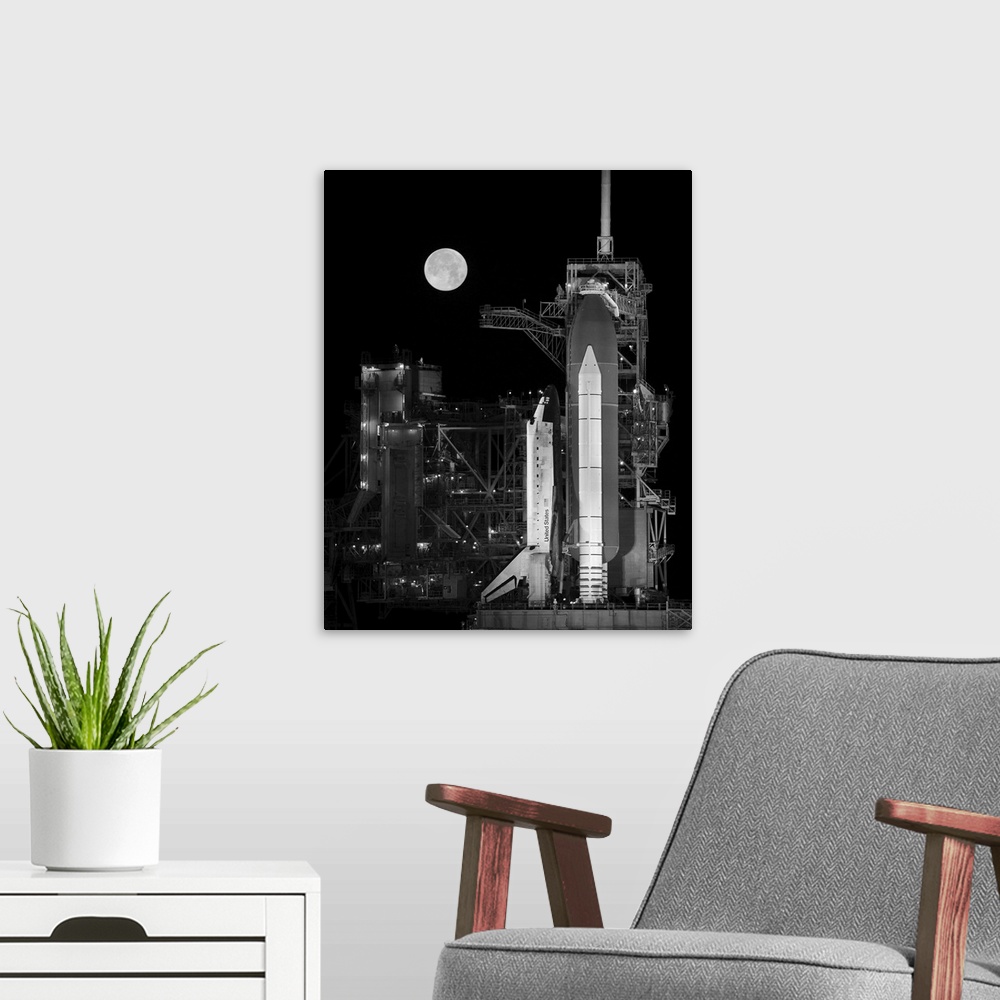 A modern room featuring Space Shuttle Discovery sits atop the launch pad with a full moon in background.