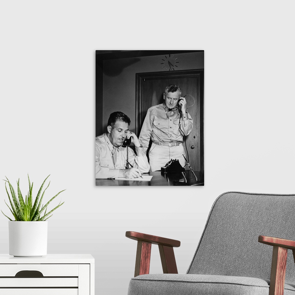 A modern room featuring World War II photograph of General Leslie Groves and General Thomas F. Farrell at work, 1945.