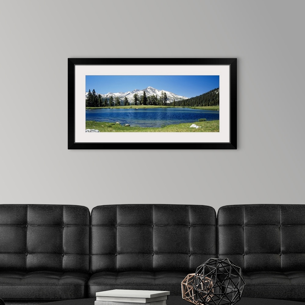 A modern room featuring Big canvas photo of a lake with snow covered mountains in the distance.