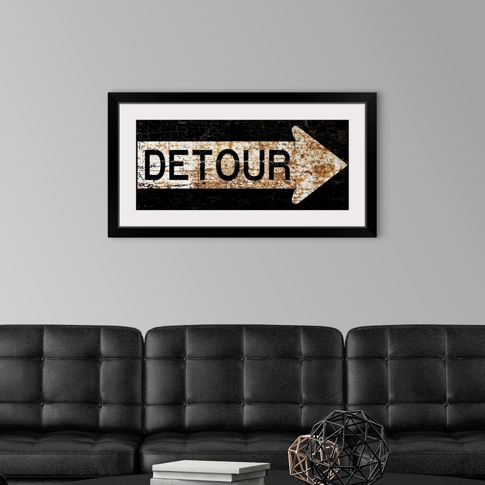 A modern room featuring A worn, distressed, cracked and rusty Detour street sign.