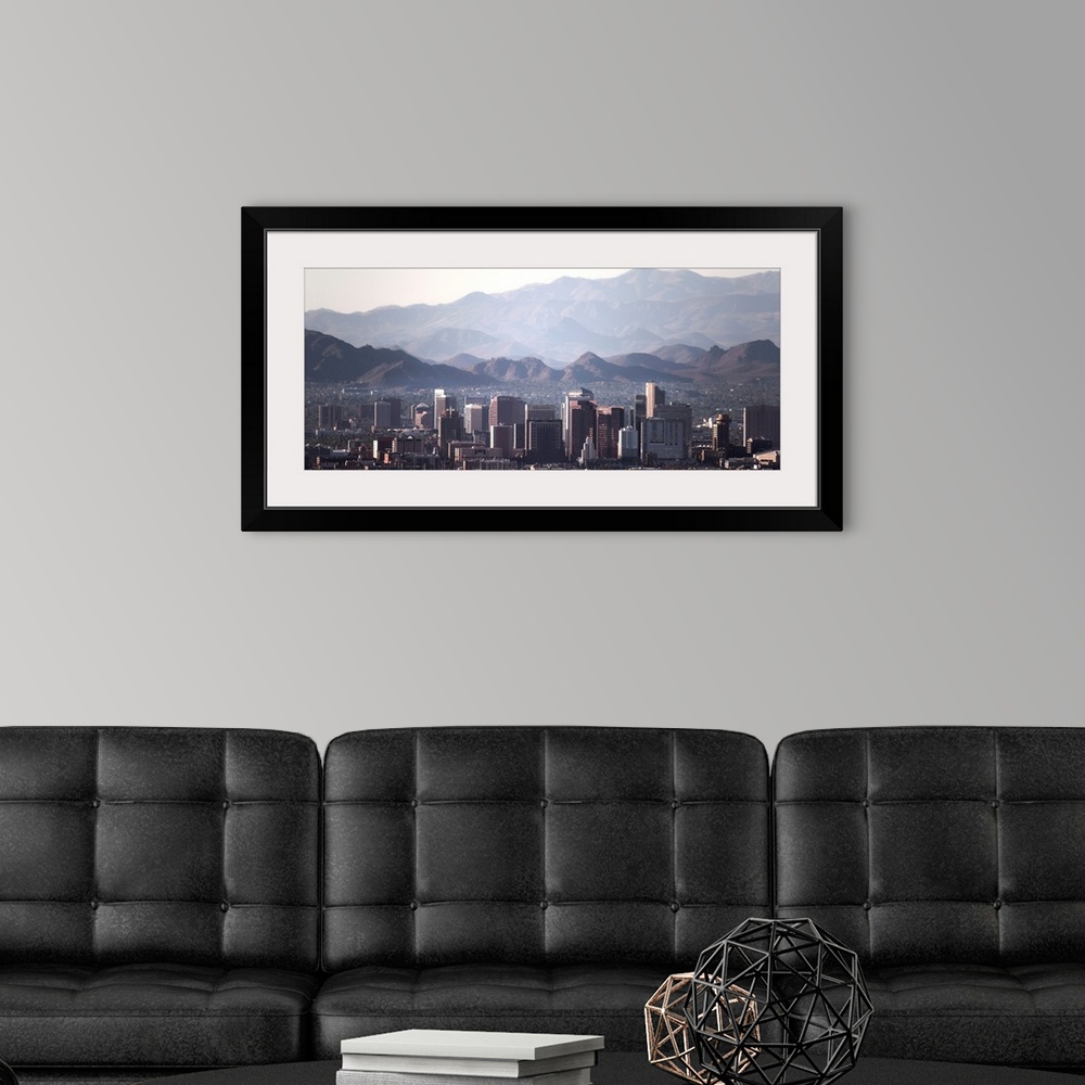 A modern room featuring Panoramic photograph of the Phoenix, Arizona skyline with hazy desert mountains in the background.
