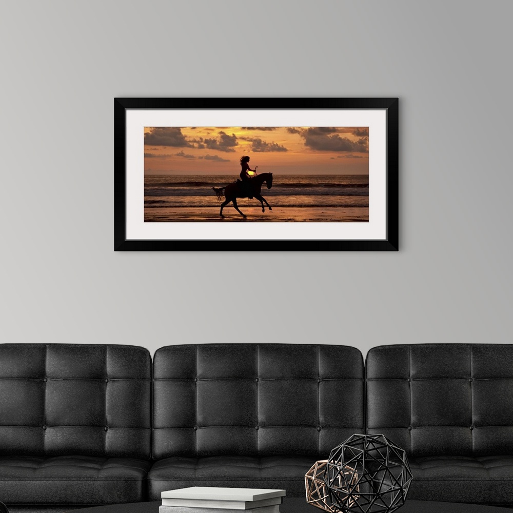 A modern room featuring Woman riding a horse on the beach at sunset in Costa Rica