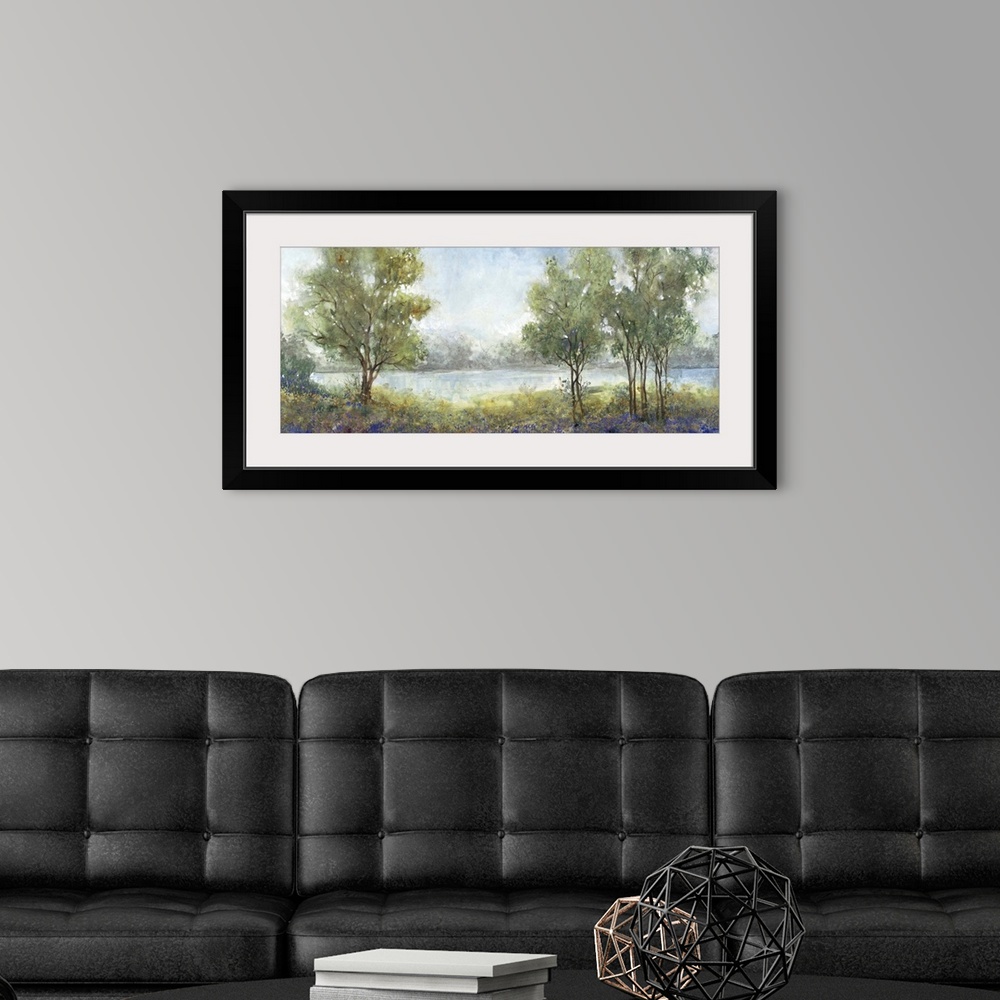 A modern room featuring Contemporary painting of an idyllic countryside scene with trees and a river.