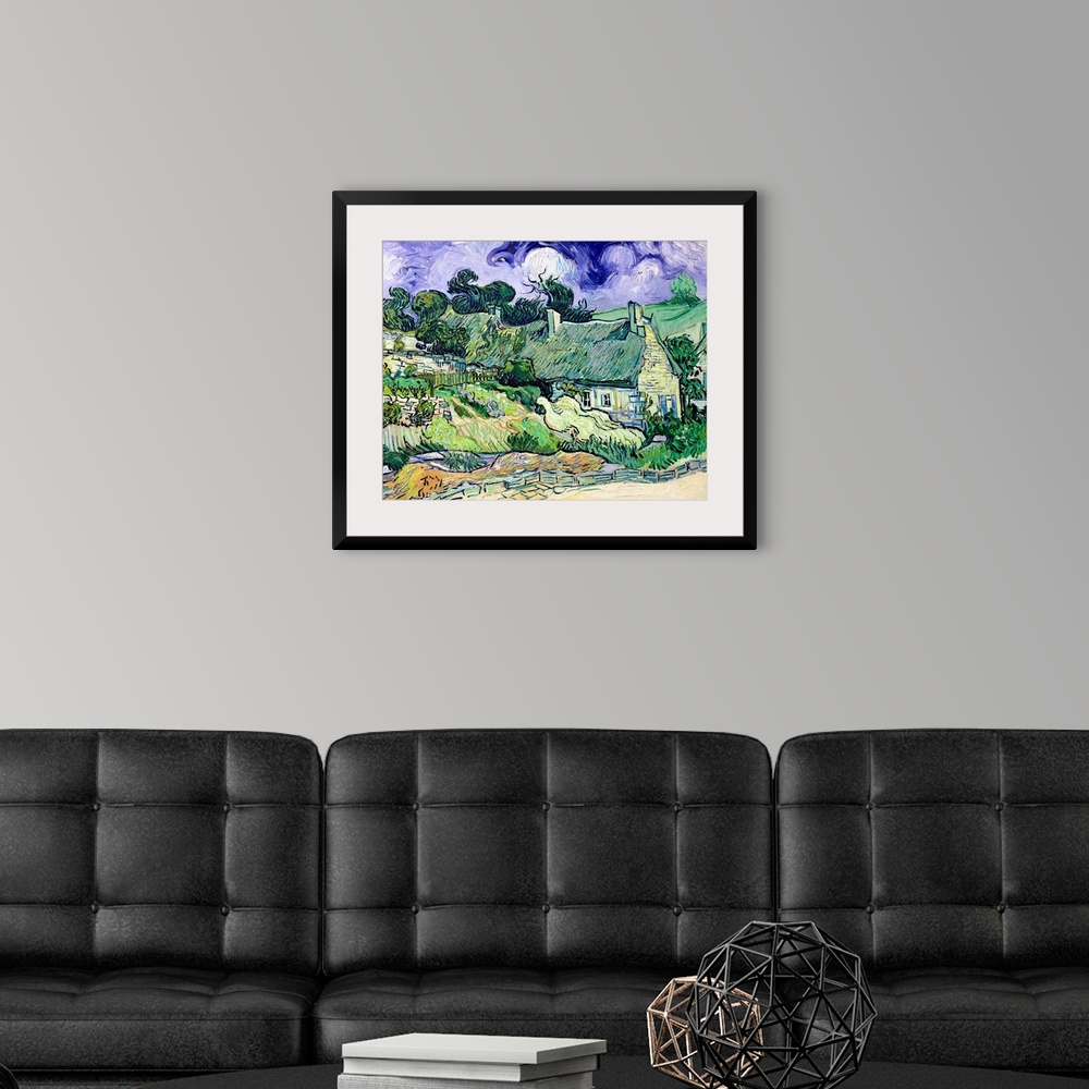 A modern room featuring Big classic art portrays a landscape filled with houses behind a cobblestone walkway in a rural a...