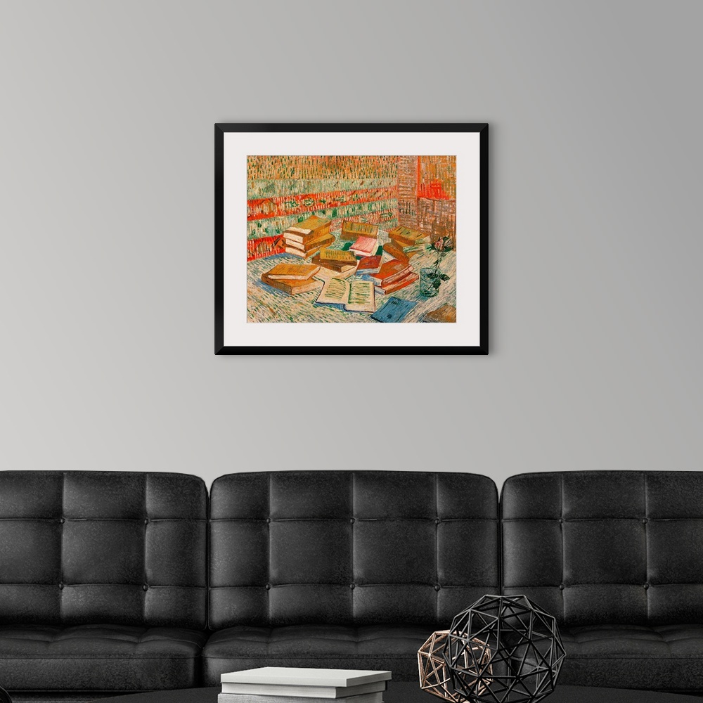 A modern room featuring Large classic art portrays a stack of different literature sitting next to a flower in a cup of w...