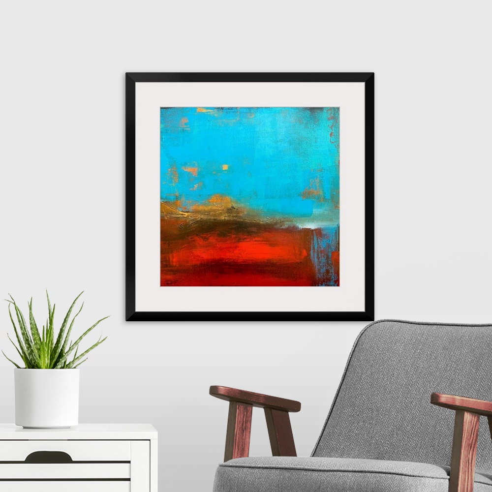 A modern room featuring Abstract canvas painting of cool tones meeting warms tones.