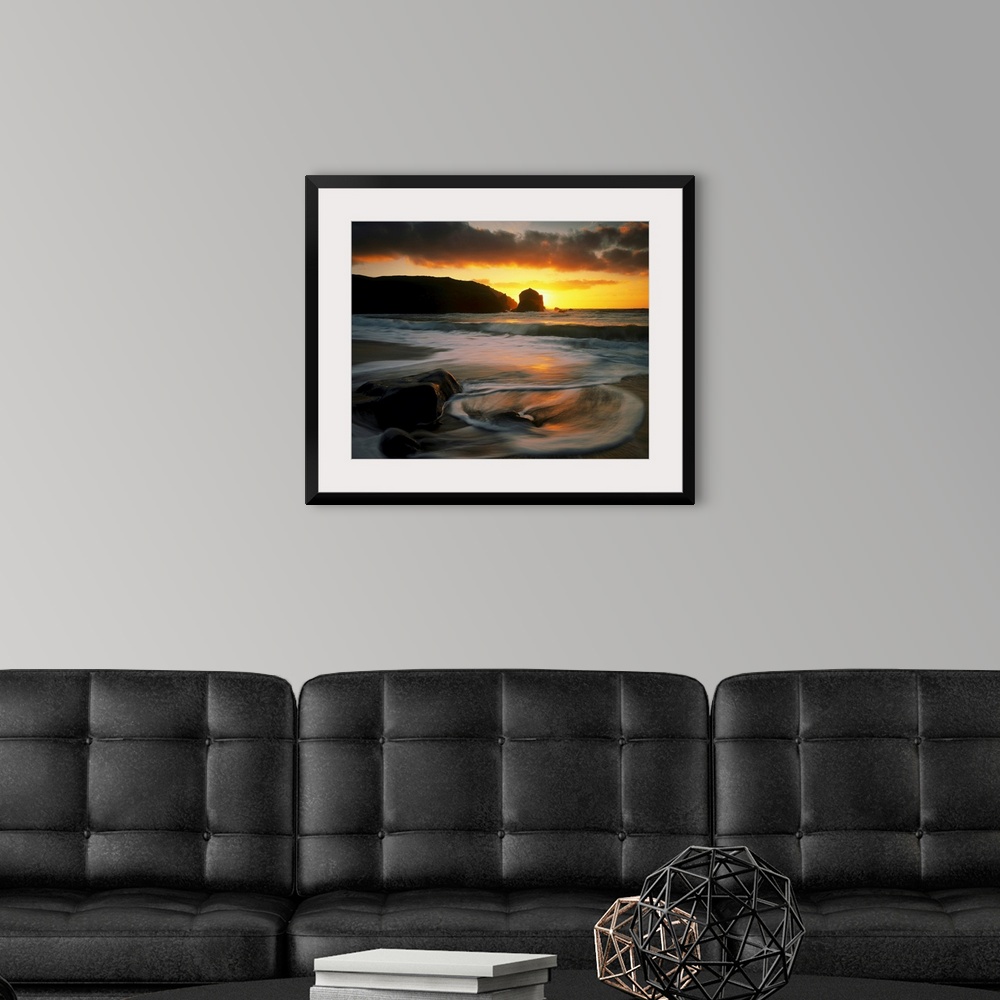 A modern room featuring Beautiful time lapsed photography wall art of waves on the beach at sunset.