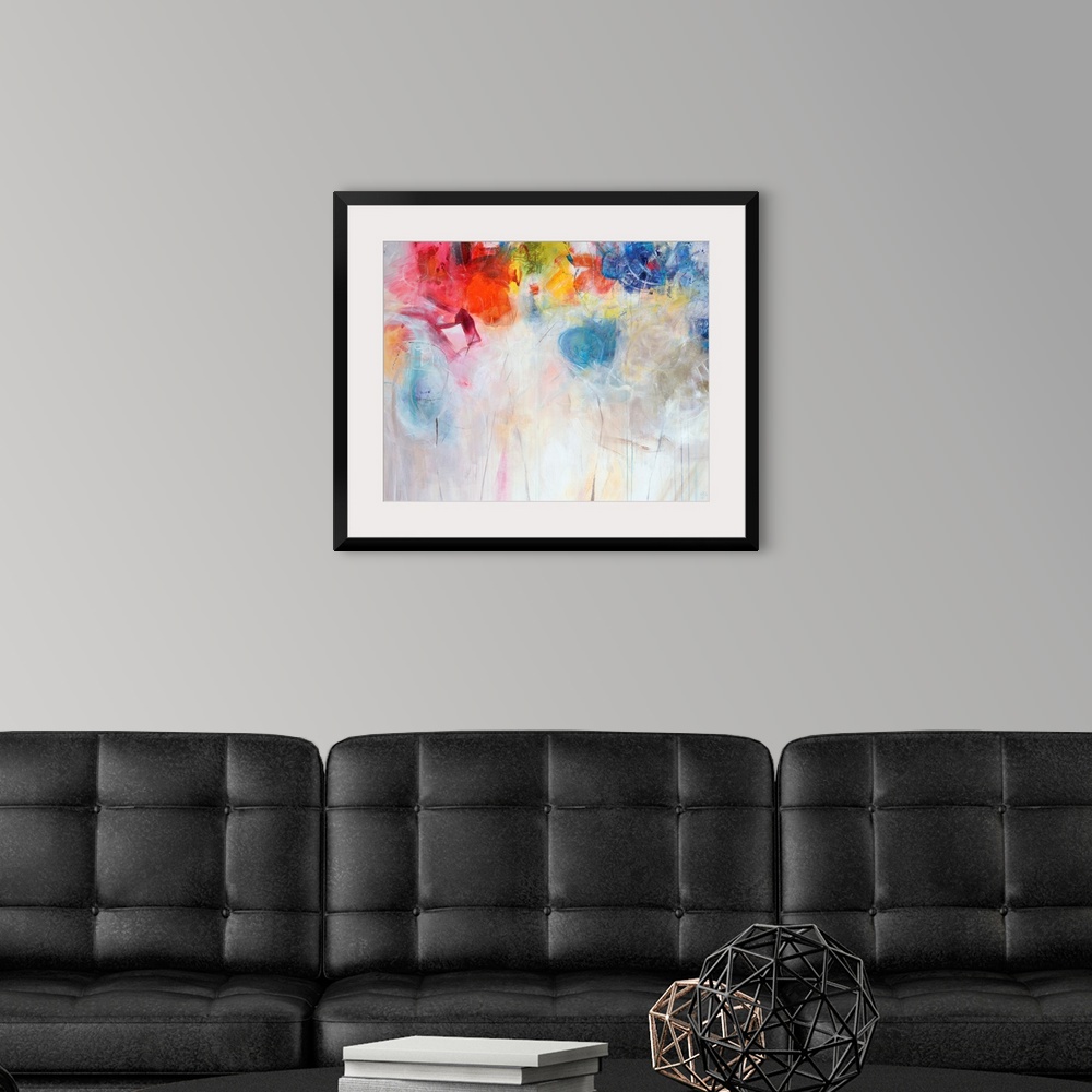 A modern room featuring Contemporary abstract painting of bright multi-colored forms overtop a neutral background.