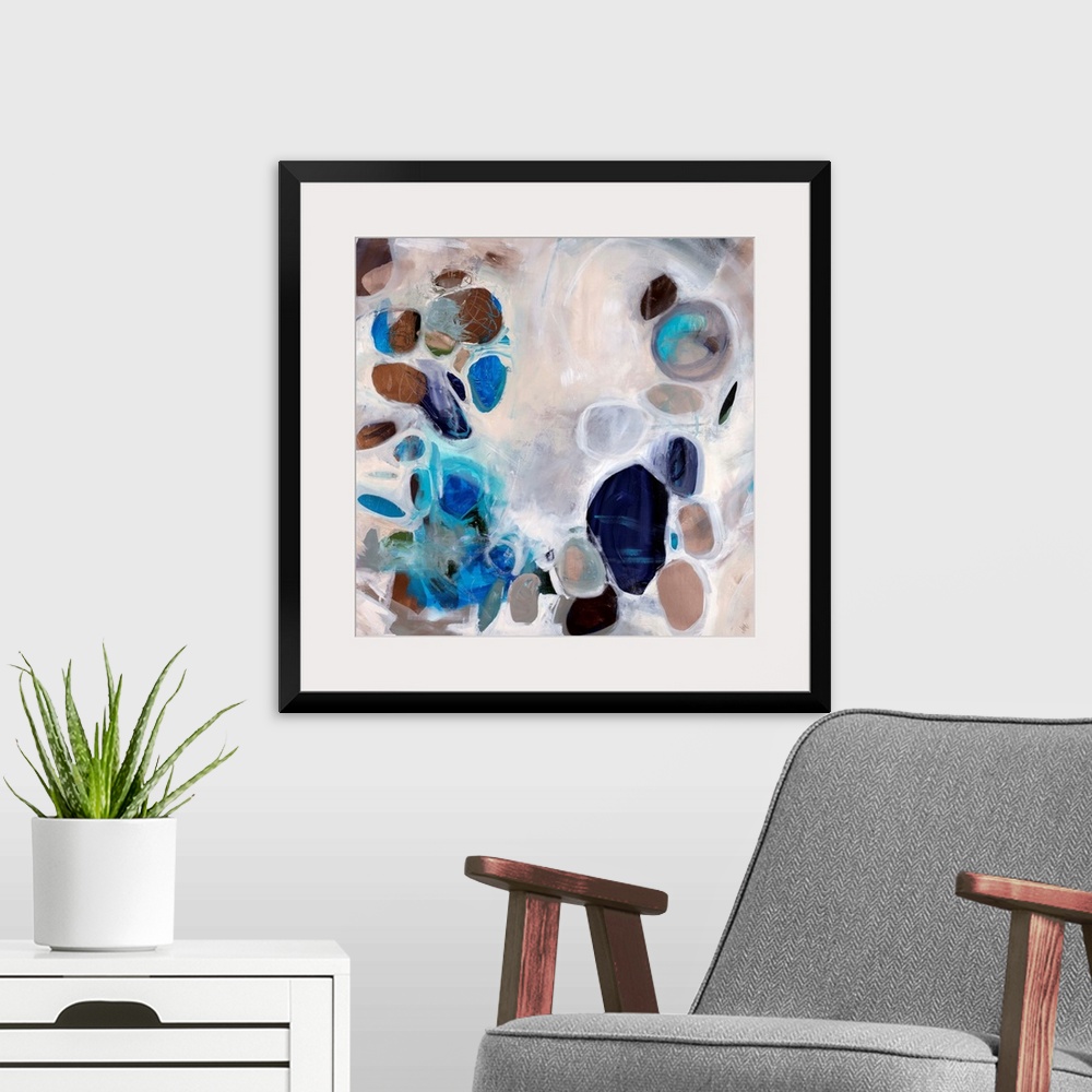 A modern room featuring Contemporary abstract painting of stone-like shapes in blues and browns over a neutral background.