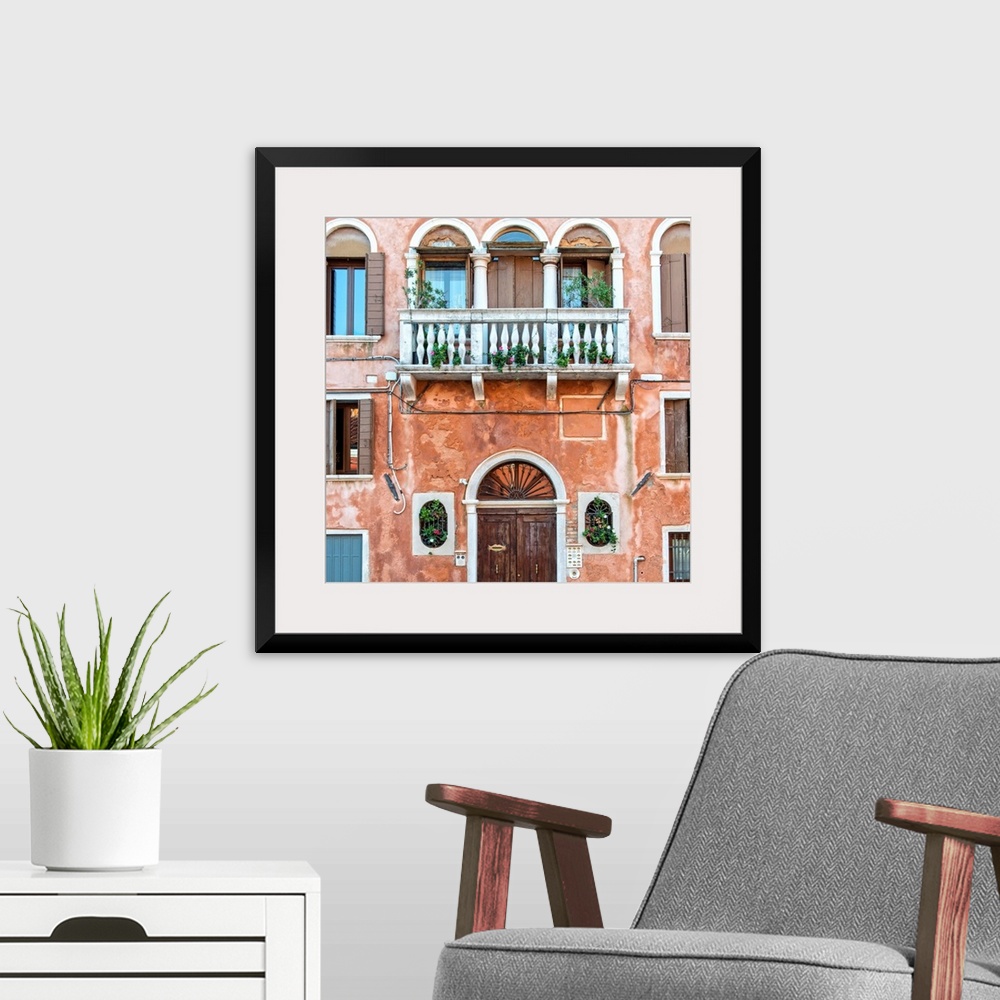 A modern room featuring Square photograph of an Italian facade in Venice with a door, windows, and a balcony.