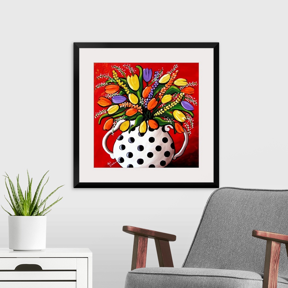 A modern room featuring Fun, brightly colored polka dot vase filled with spring flowers and Tulips.