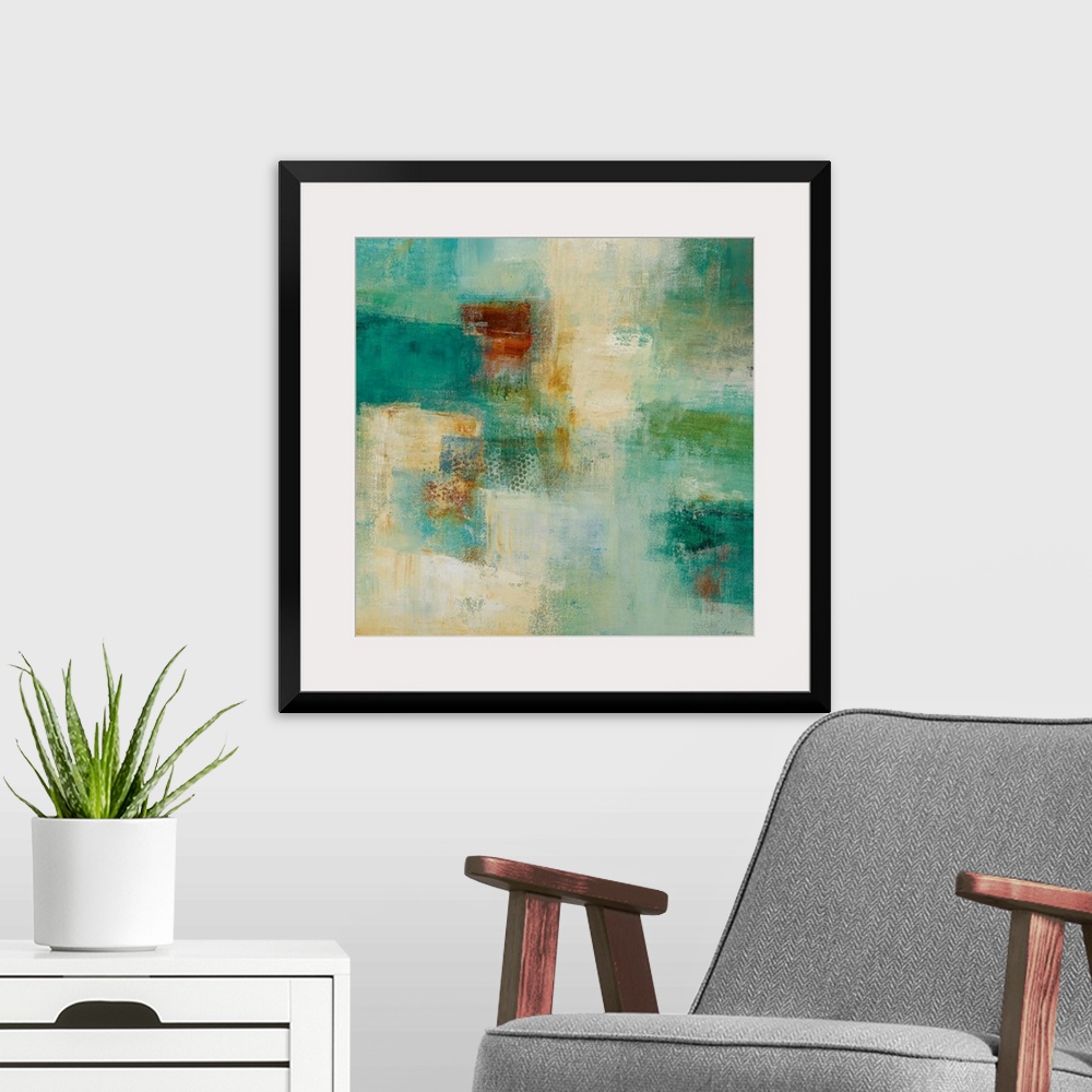 A modern room featuring Square abstract painting with warm and cool patches of color in rough textures.