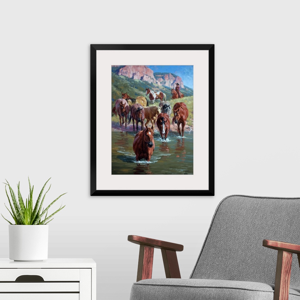 A modern room featuring Contemporary Western artwork of a herd of wild horses forging a river, being herded by a cowboy.