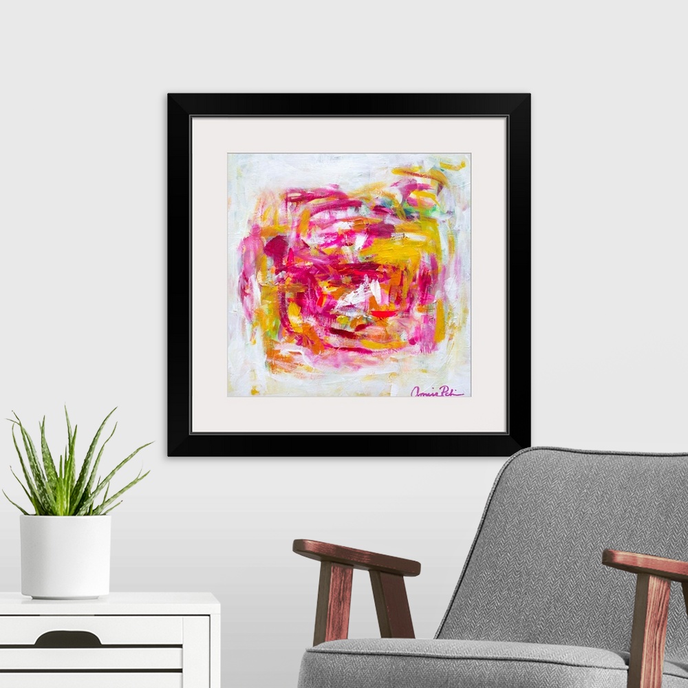 A modern room featuring Abstract contemporary artwork in cheerful pinks and yellows.