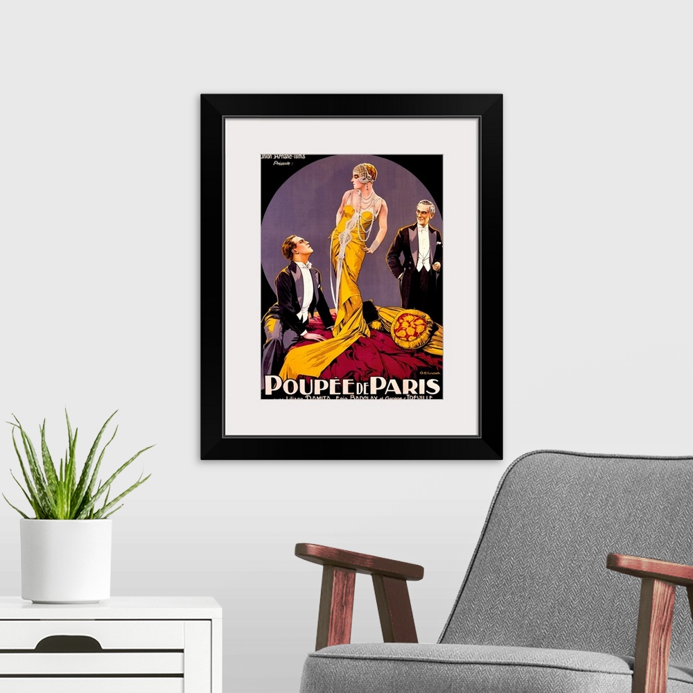 A modern room featuring A large vertical vintage poster with two men in tuxedos staring at a tall woman in the center wea...