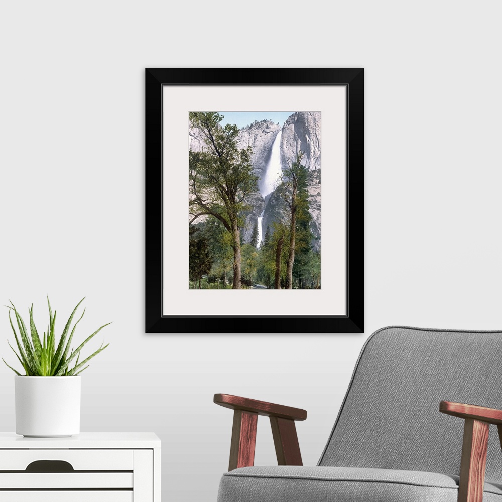 A modern room featuring Big, vertical photograph of Yosemite Falls seen through the trees in Yosemite Valley, California.