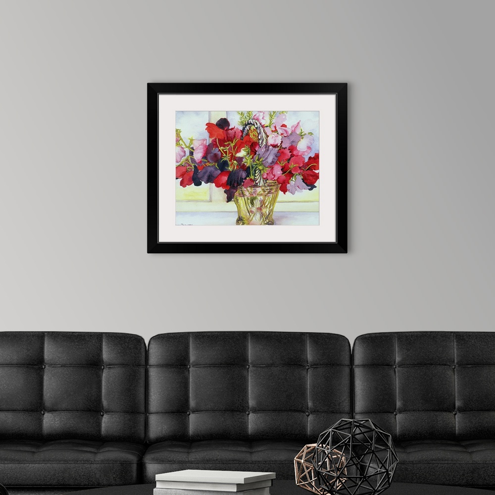 A modern room featuring Painting of colorful flowers in a brass container sitting on a table.