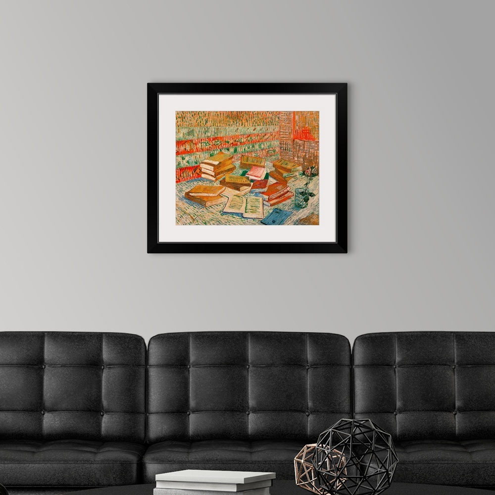 A modern room featuring Large classic art portrays a stack of different literature sitting next to a flower in a cup of w...