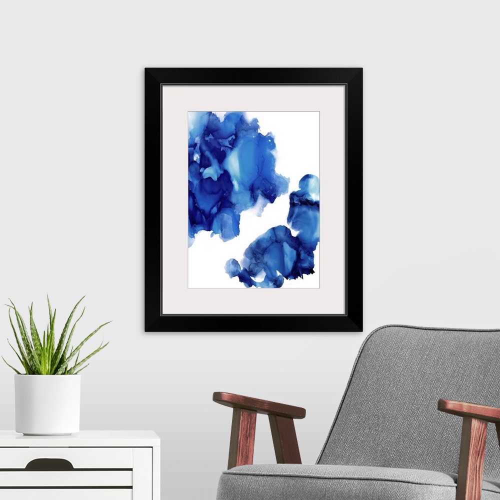 A modern room featuring Abstract painting with indigo hues splattered together on a white background.