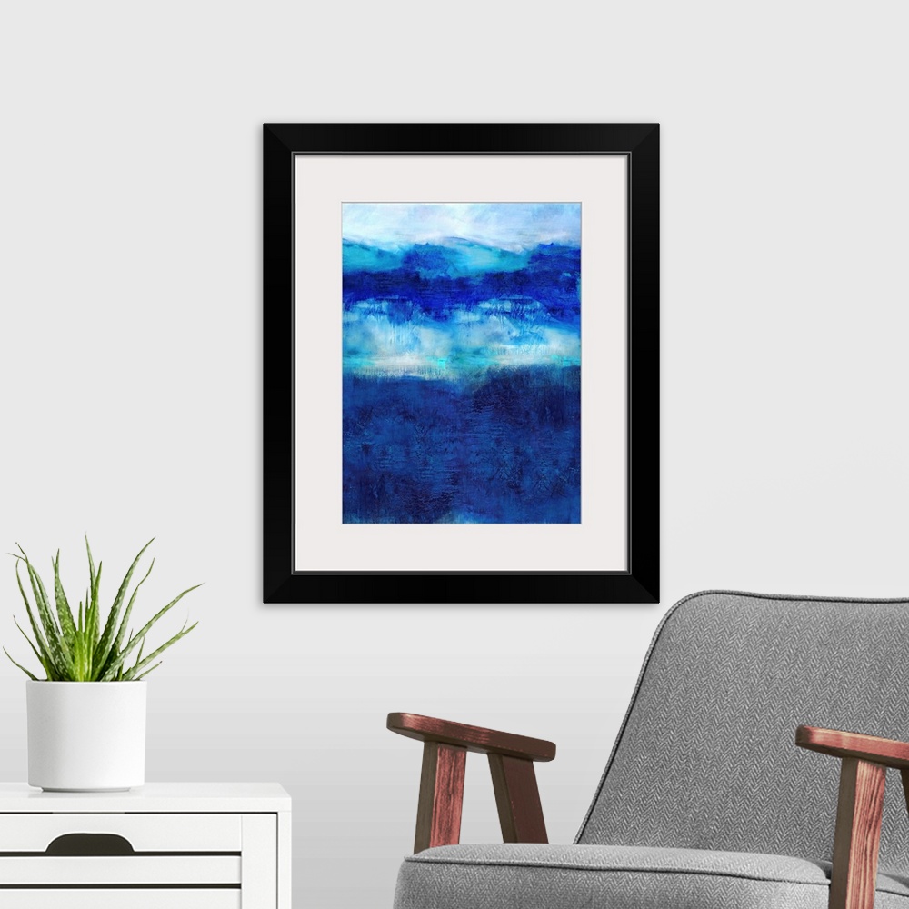 A modern room featuring Vertical abstract painting created with deep shades of blue on a white background.