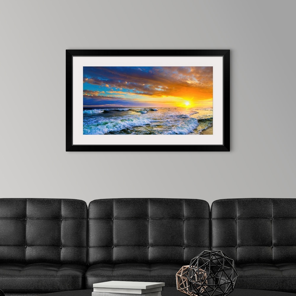 A modern room featuring A beautiful red sunset panorama of an ocean sunset. This landscape features a red ocean sunset wi...