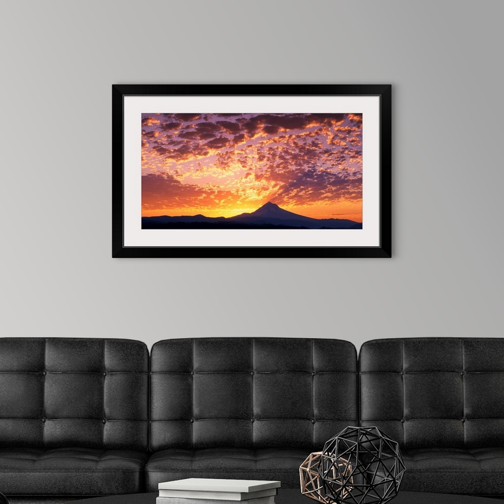 A modern room featuring Intense sunset colors in the clouds over Mount Hood.