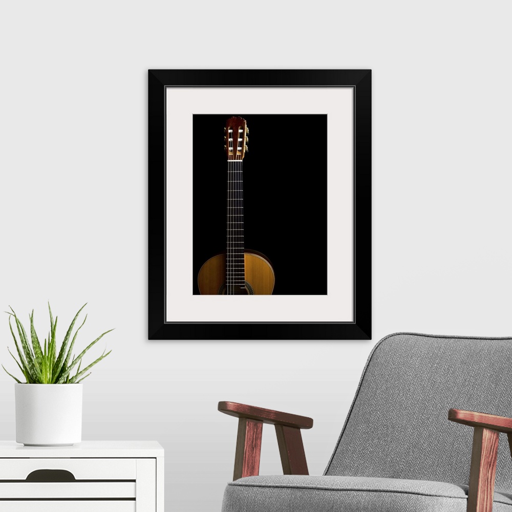 A modern room featuring Close-up of acoustic guitar on black