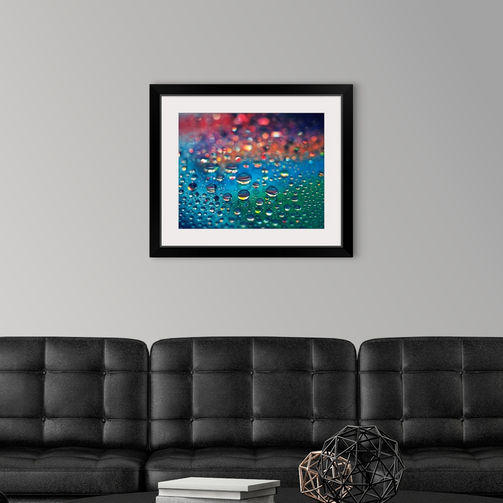 A modern room featuring Landscape, close up photograph of dew drops of various sizes on a rainbow colored surface, using ...