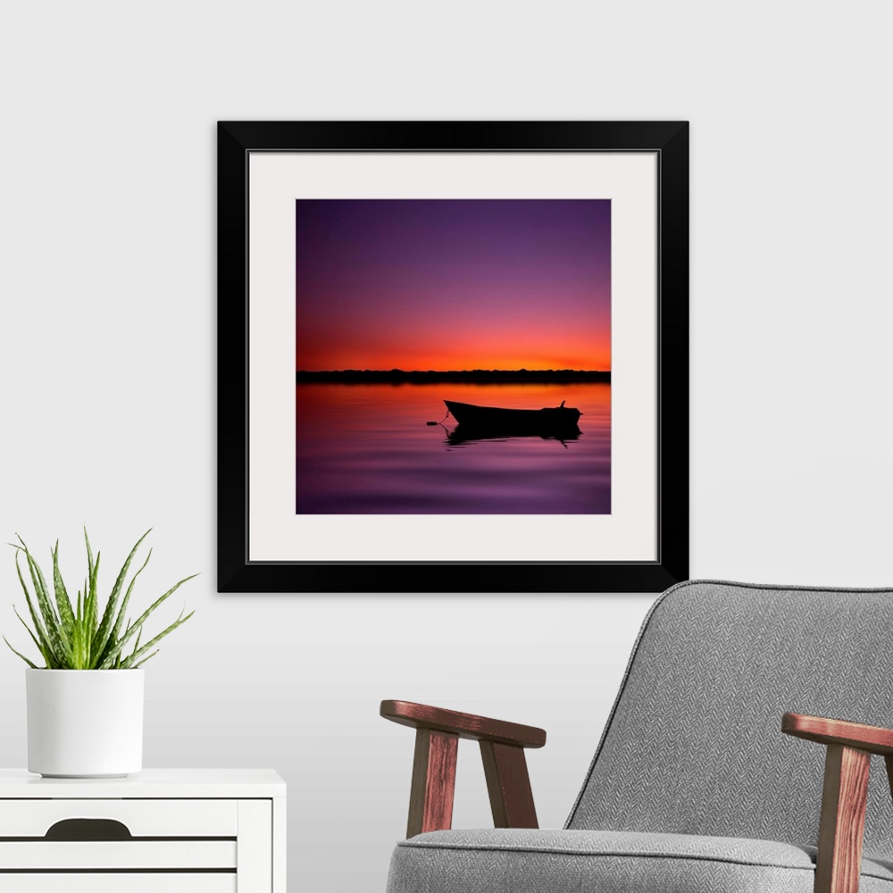 A modern room featuring Silhouette boat in lake with sunset.