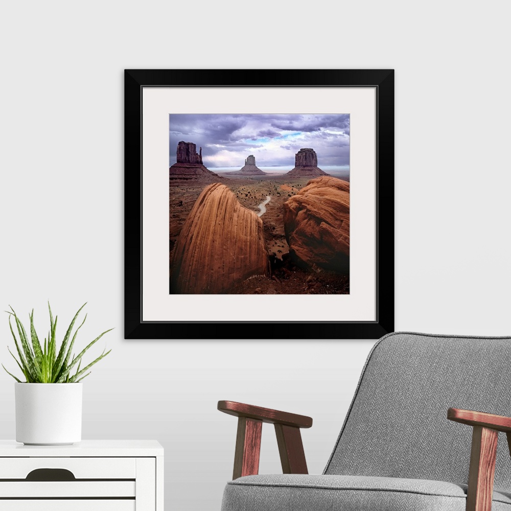A modern room featuring A photograph of monument valley under a purple cloudy sky.