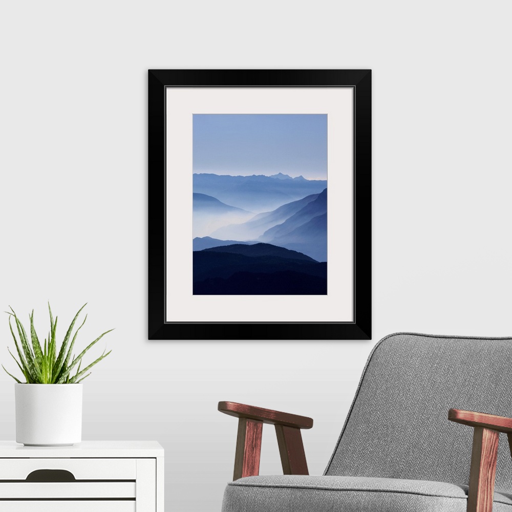 A modern room featuring A photograph of clouds along the blue ridge mountains.