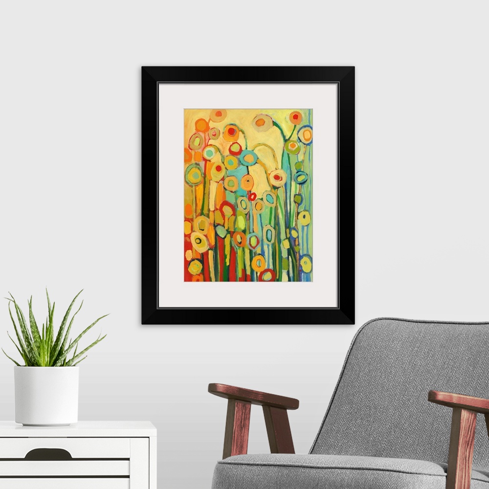A modern room featuring Vertical, abstract painting of simplified flower shapes in a kaleidoscope of colors.