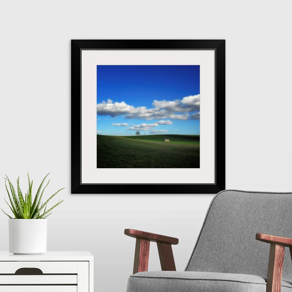 A modern room featuring Countryside landscape with blue sky and clouds