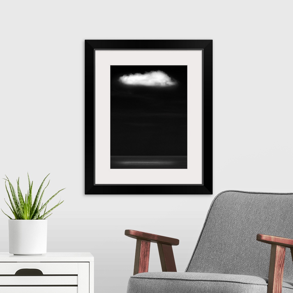 A modern room featuring A zen-like monochrome black and white seascape with a flat calm sea and a single white fluffy clo...