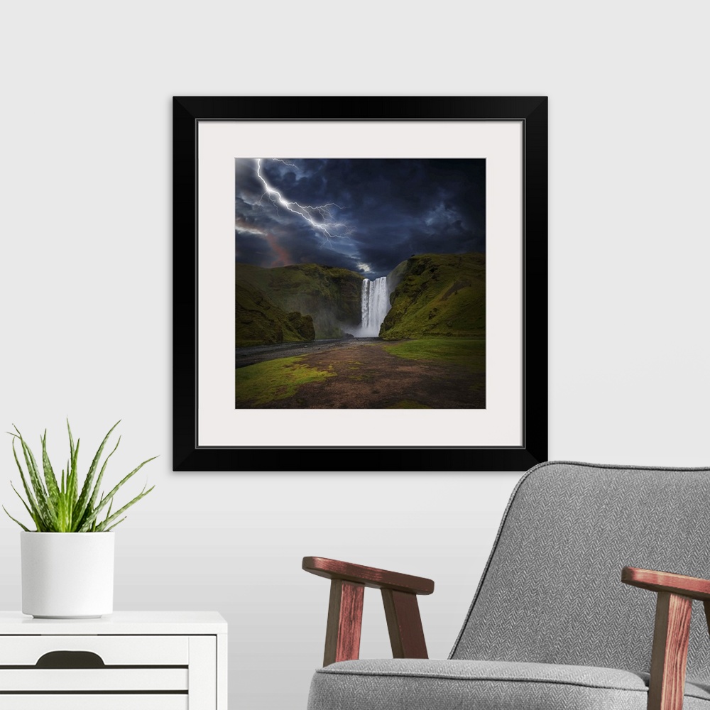 A modern room featuring A photograph of lightning striking over a landscape with a waterfall in the distance.