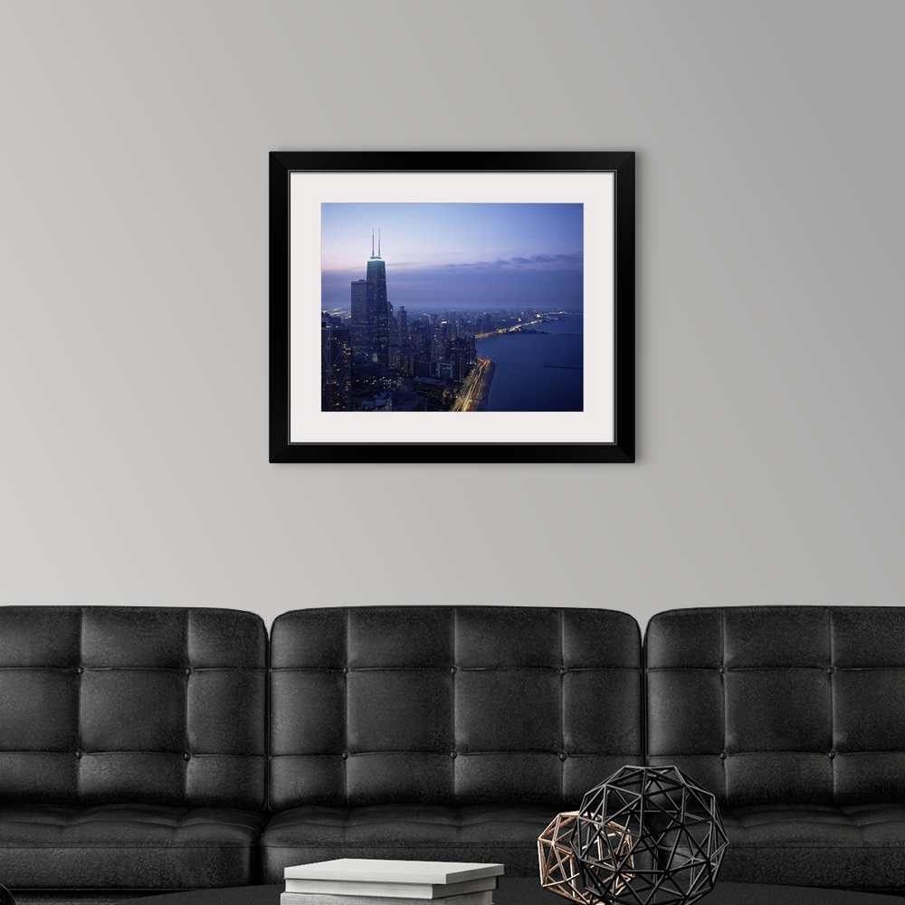 A modern room featuring This large piece is a photograph taken of Chicago during dusk showing the busy city to the left a...