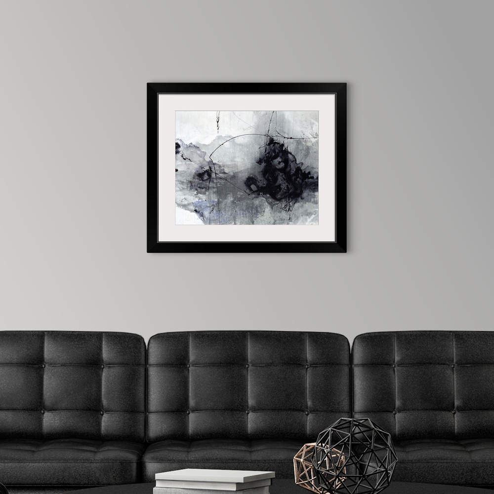 A modern room featuring Contemporary painting of a black and gray cloud-like shape against a neutral background.
