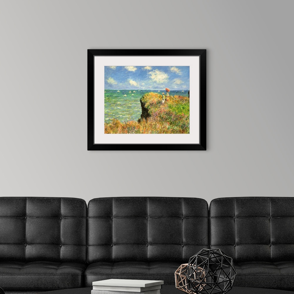 A modern room featuring Painting of people on grassy cliff overlooking ocean full of sailboats under a cloudy sky.