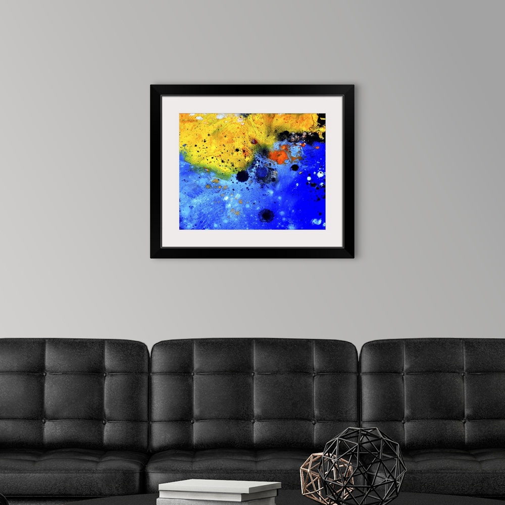 A modern room featuring Abstract painting of colors of blue, black and yellow with hints of red in textured brush strokes...