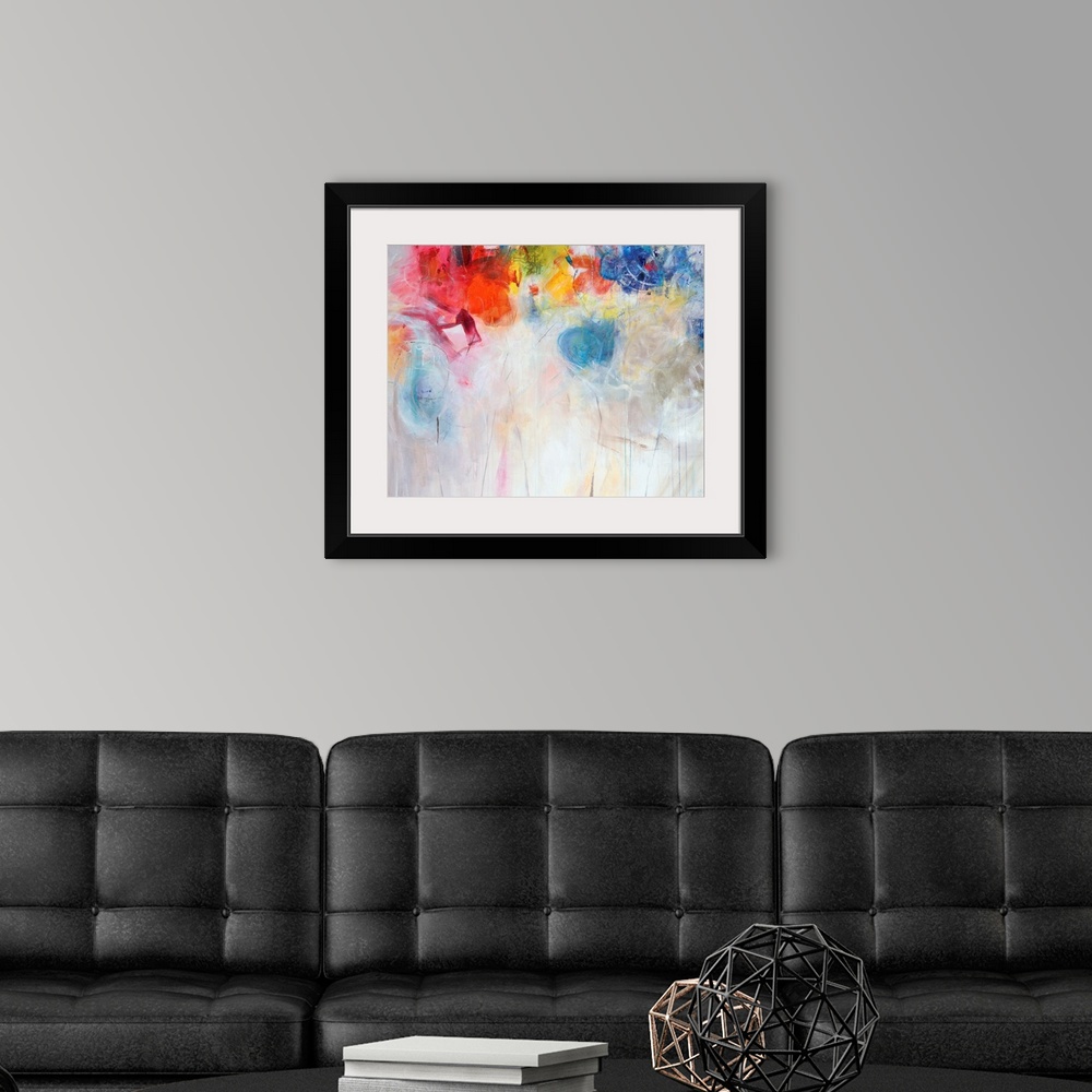 A modern room featuring Contemporary abstract painting of bright multi-colored forms overtop a neutral background.