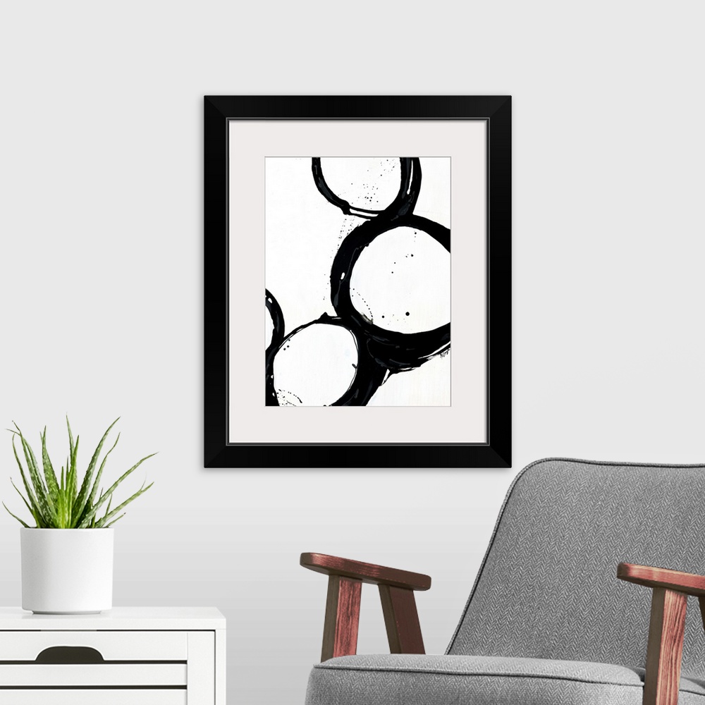 A modern room featuring Giant monochromatic abstract art includes a set of four uneven and irregular circles positioned n...