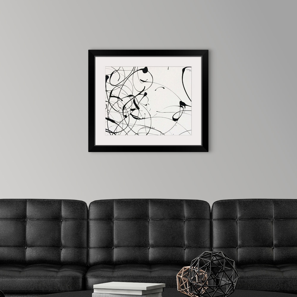 A modern room featuring A contemporary abstract painting of black paint drizzle on a tan background.