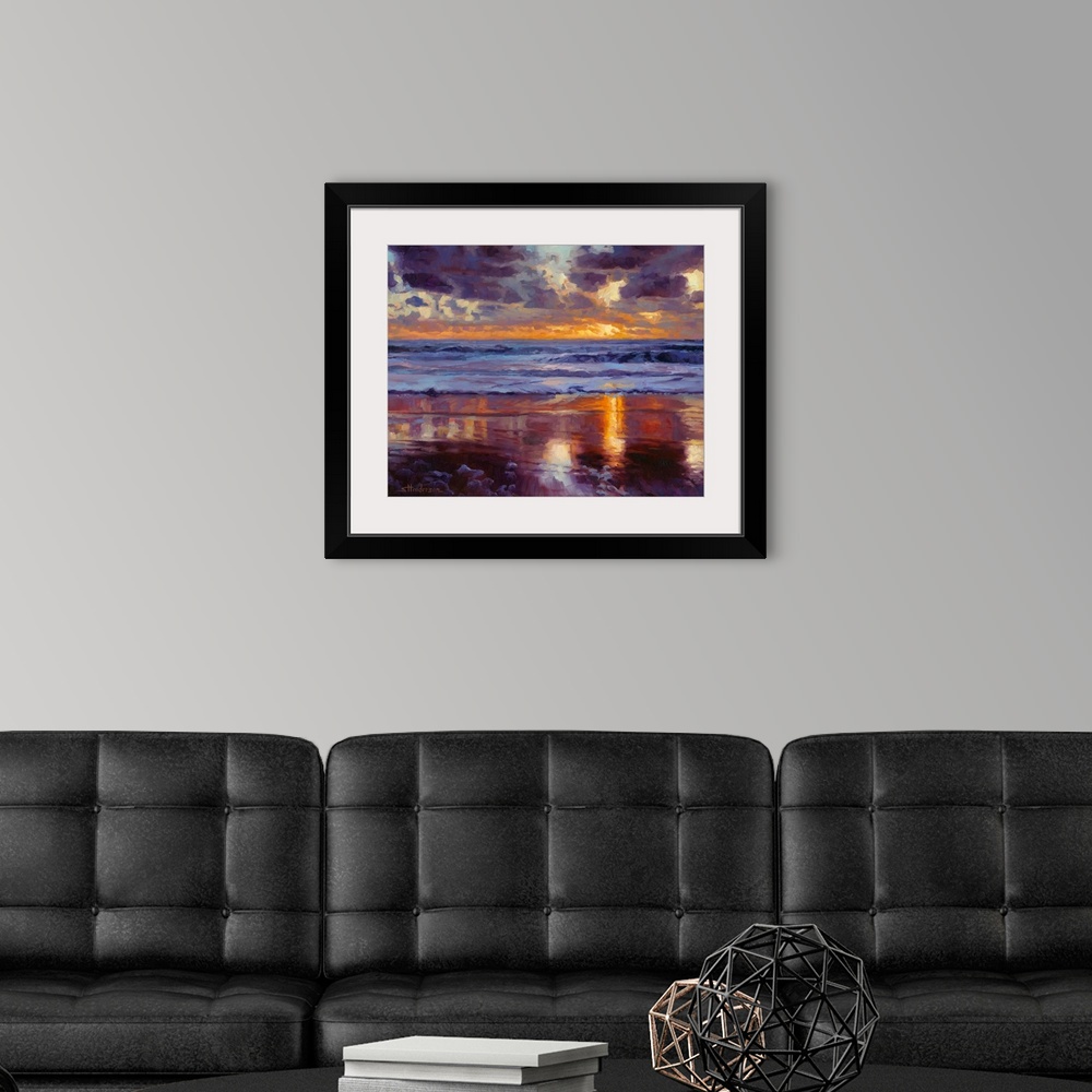 A modern room featuring Traditional impressionist painting of a beach at sunset, showing sand, water, and sky in varying ...