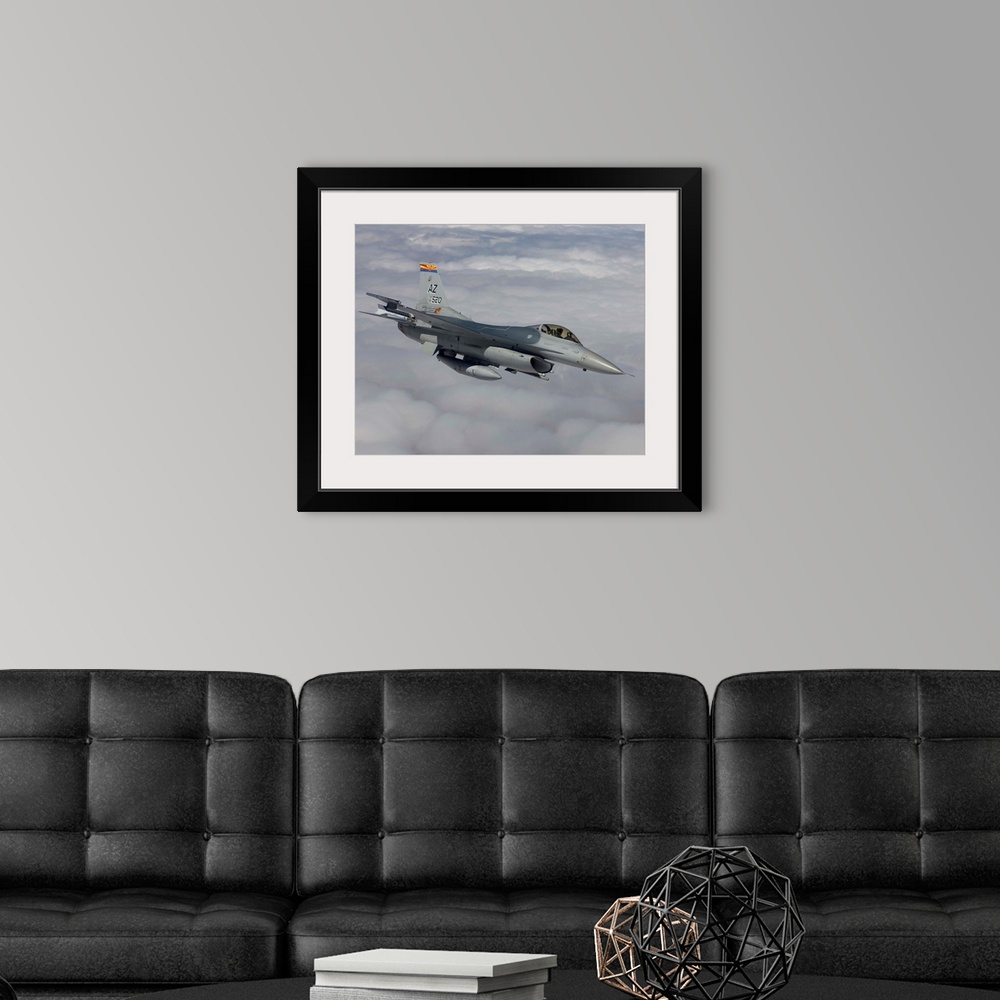 A modern room featuring An F-16 Fighting Falcon from the 162nd Fighter Wing maneuvers during a training mission out of Tu...